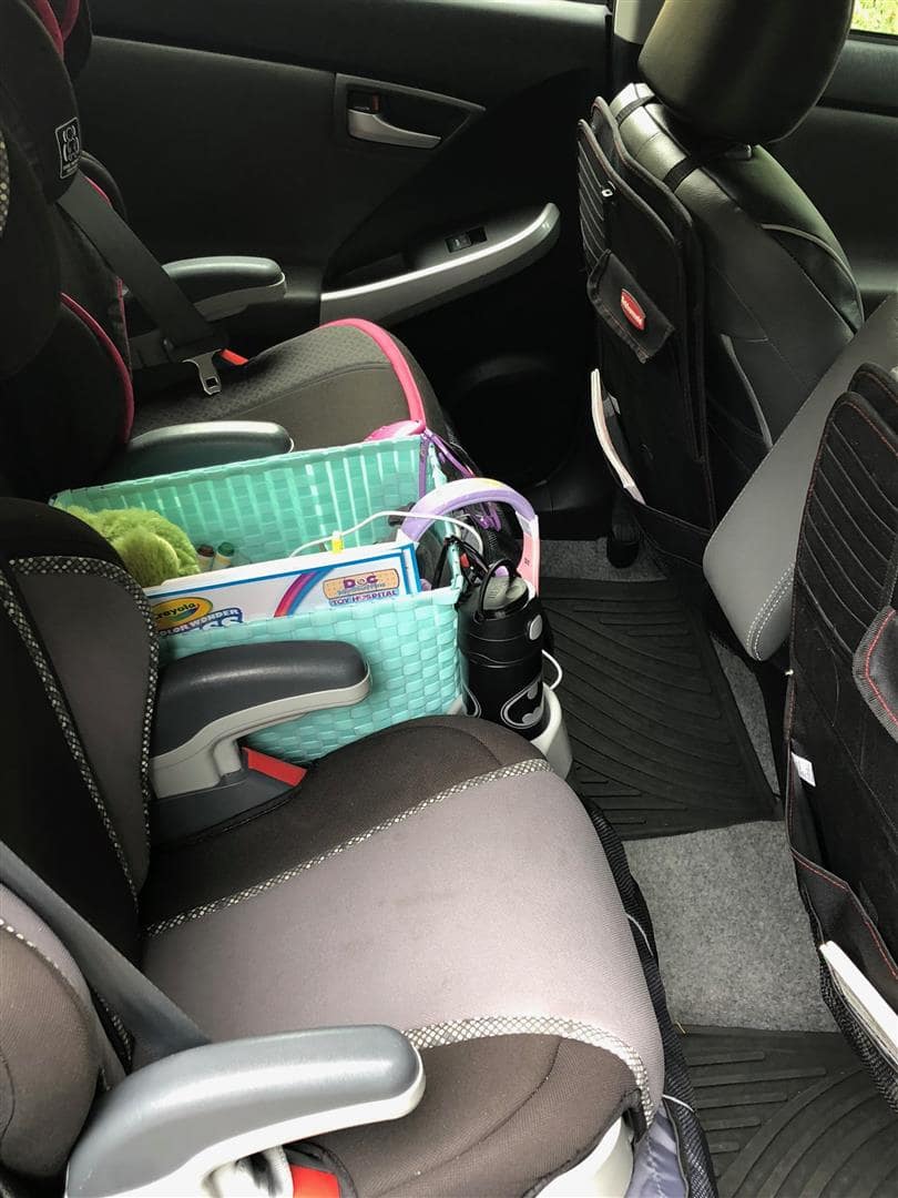 Car interiors featuring a backseat basket for kids' toys and water